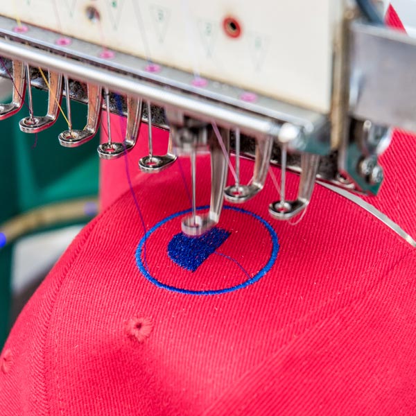 red hat being embroidered
