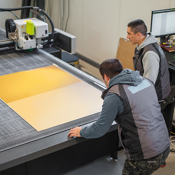 two men sign printing